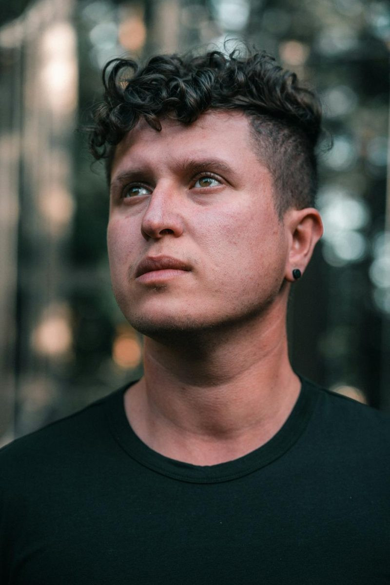 Man with a curly french crop and short faded sides