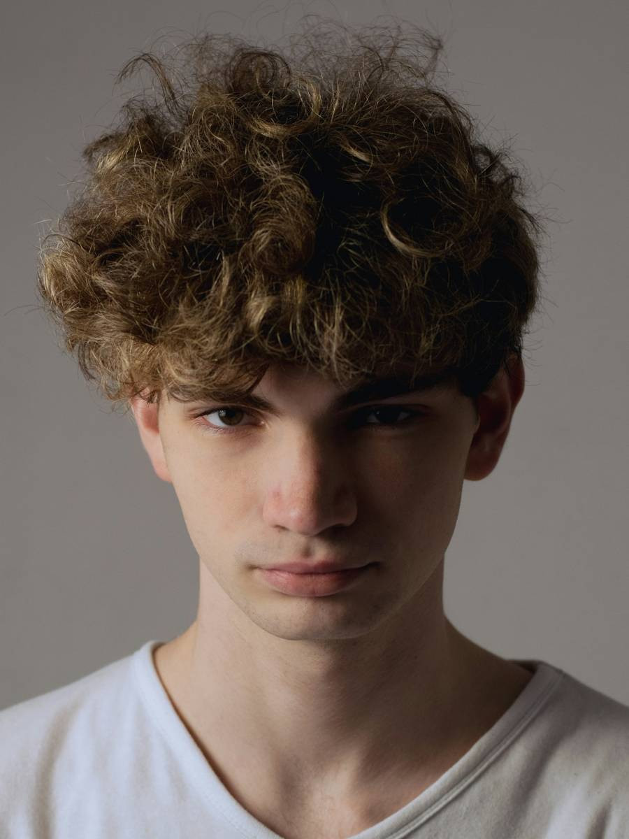 Man with a curly textured crop and soft fringe