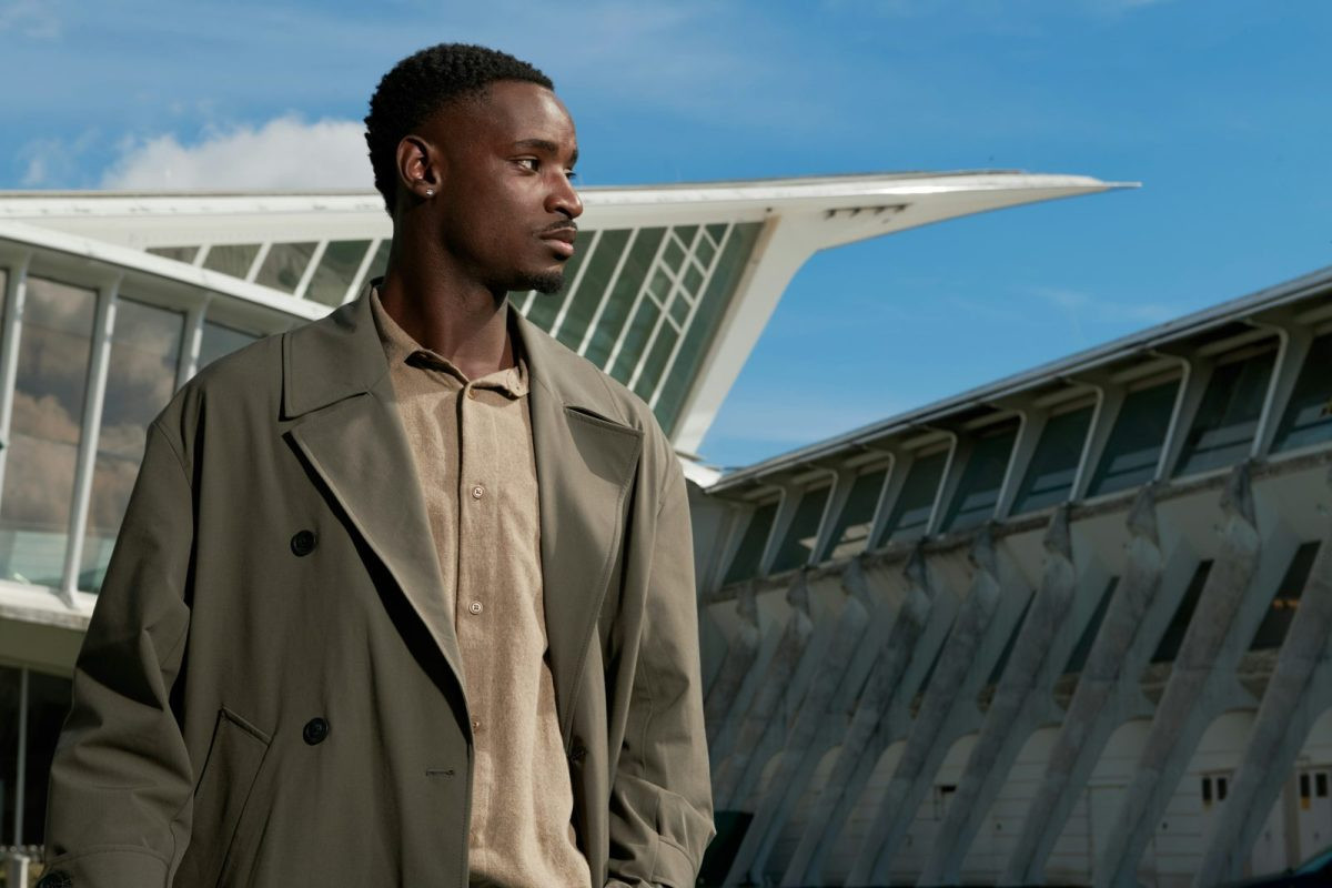 Man in an olive-khaki trench coat in the city