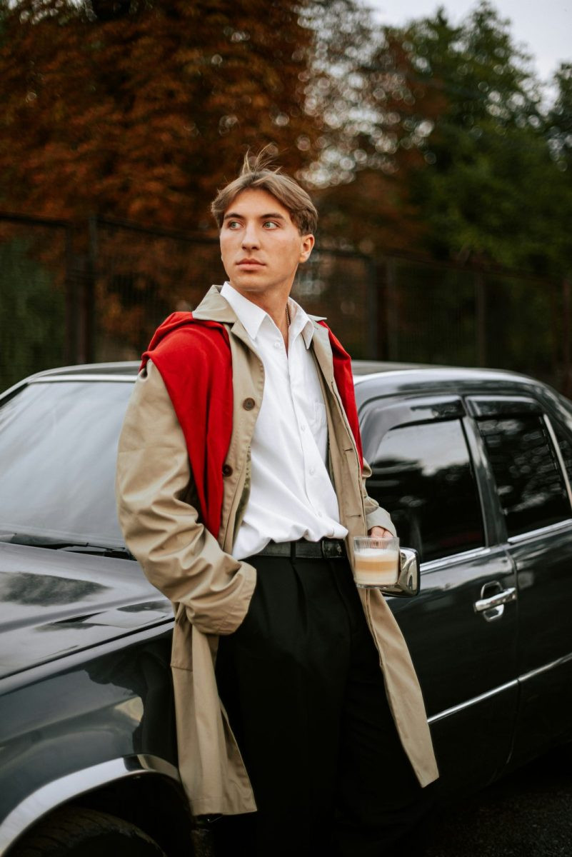 Man in a camel trench over light knit layers