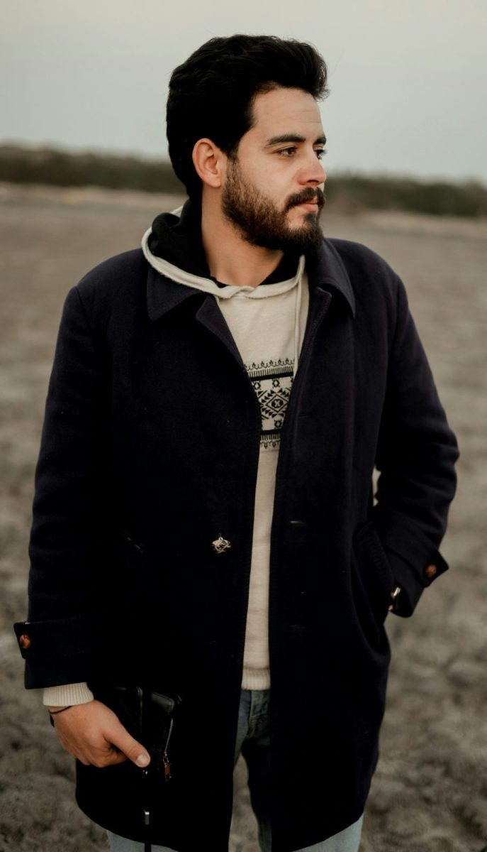 Man in a dark casual overcoat over a hoodie