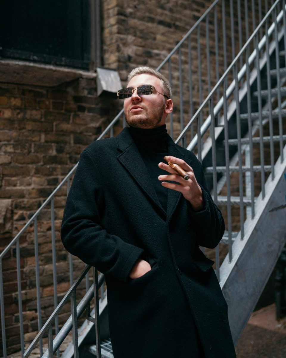 Man in a black trench over a turtleneck