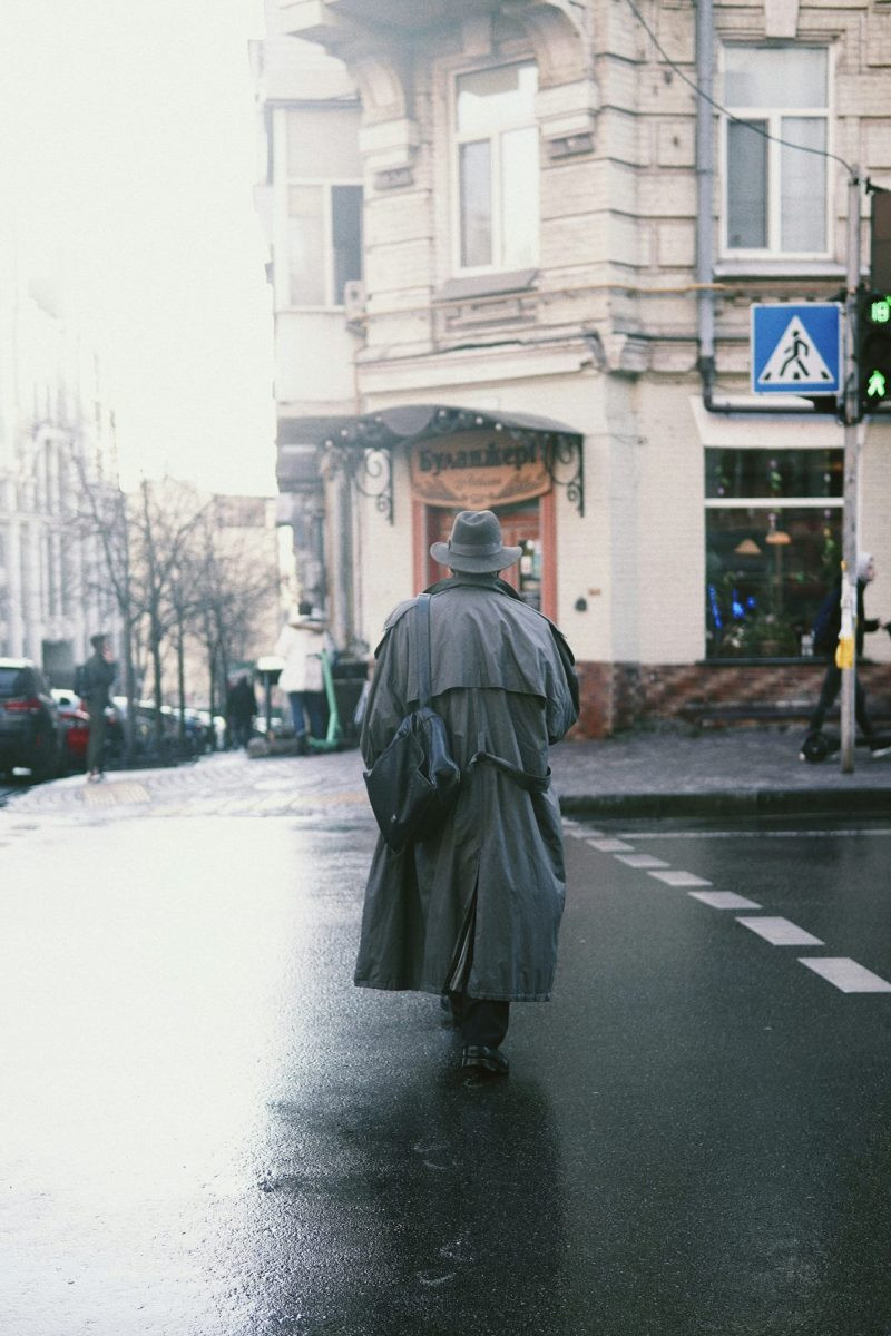 Man in a dark coat on a rainy city day