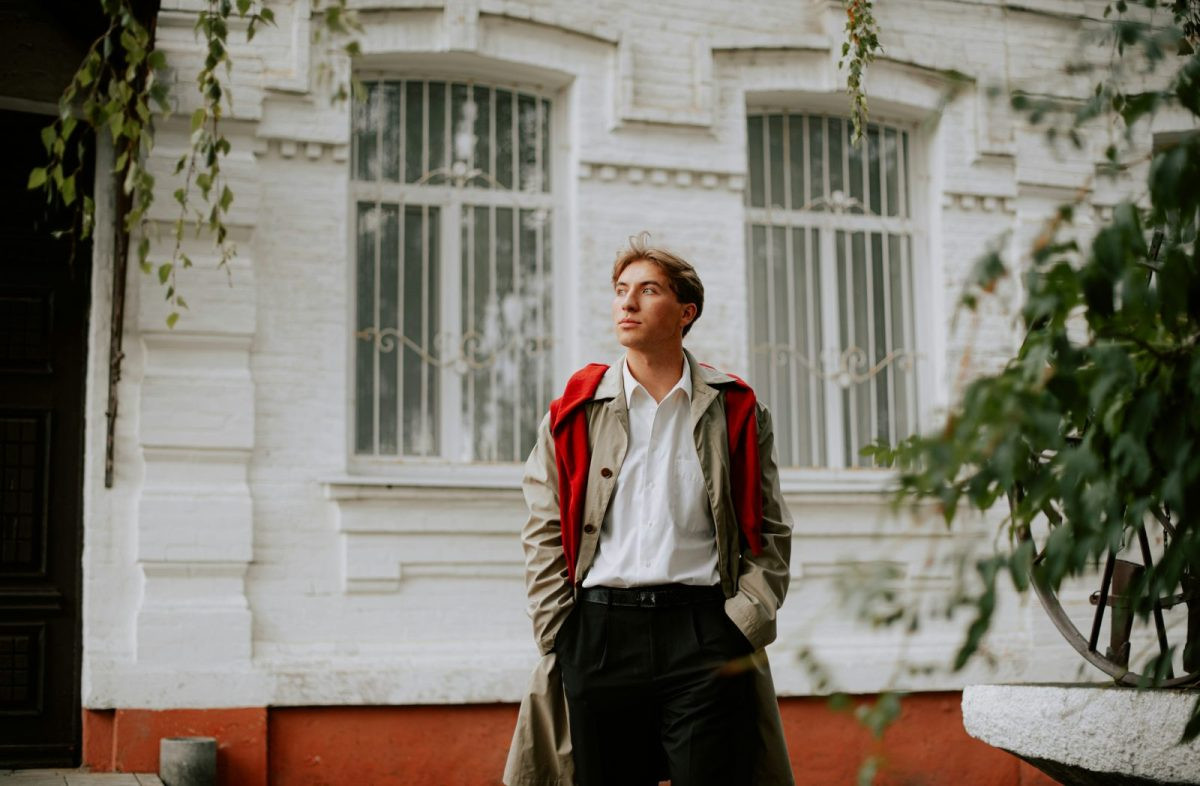Man in light outerwear over a collared shirt